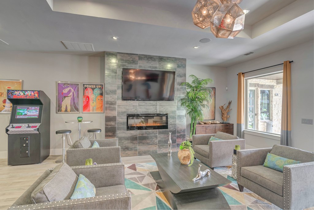 A modern living room with a fireplace and a television.