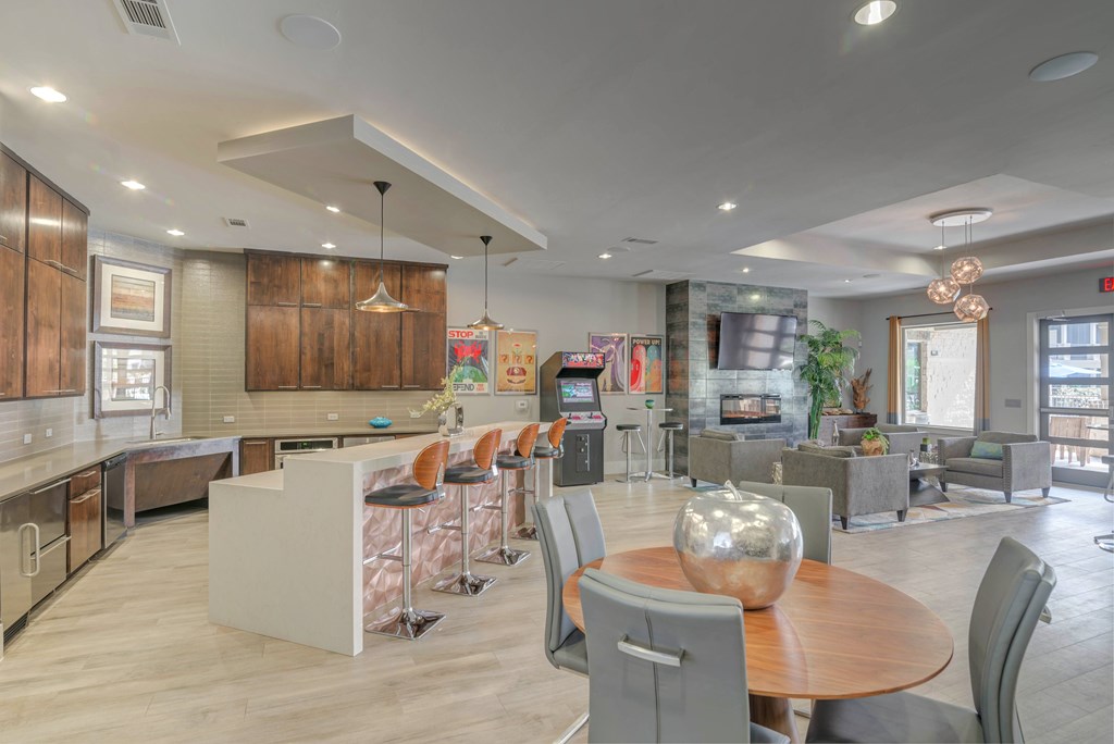 A modern open-concept living space with a kitchen, dining area, and living room.