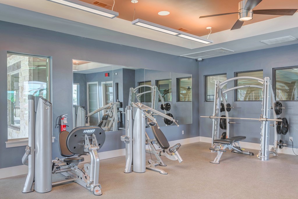 A gym with a variety of exercise equipment.