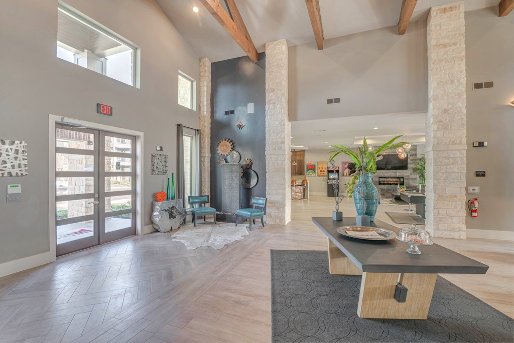 A modern living room with a wooden floor and a large window.