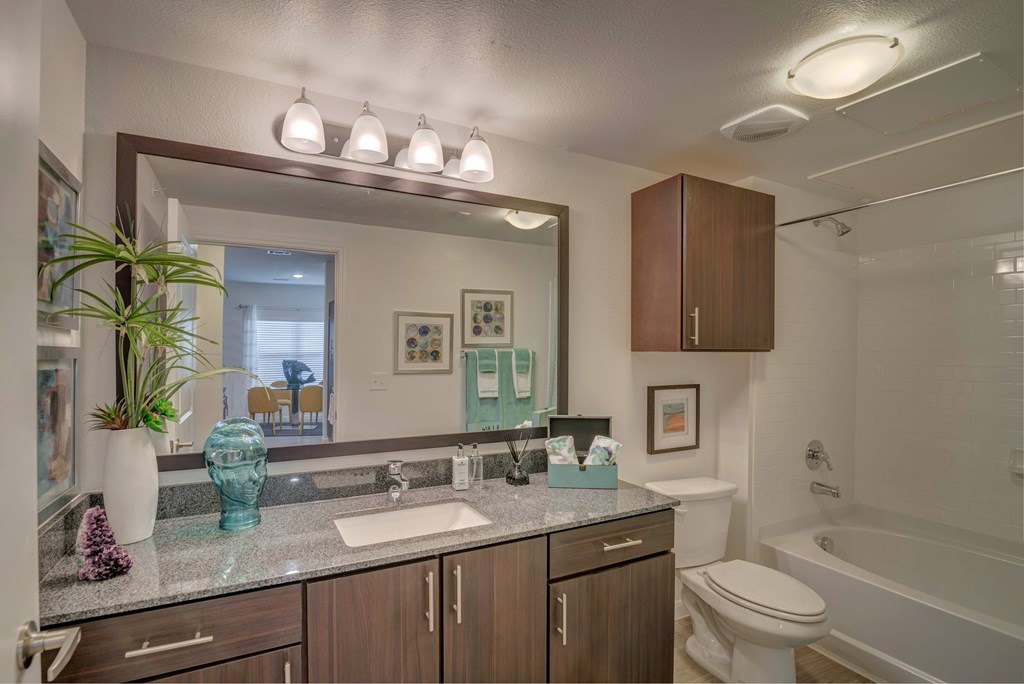 A bathroom with a sink, toilet, and bathtub.