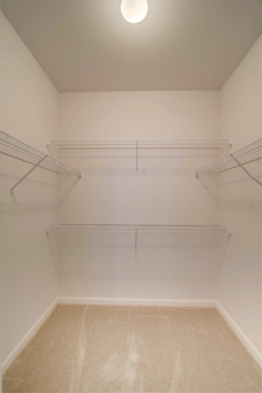 Empty white closet with three shelves.