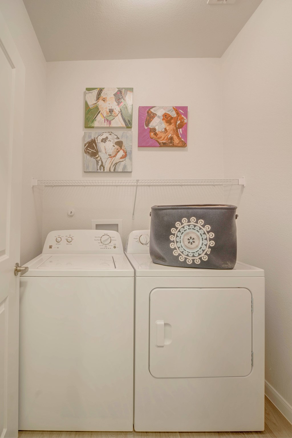 A grey bag with a white design sits on top of a washing machine.