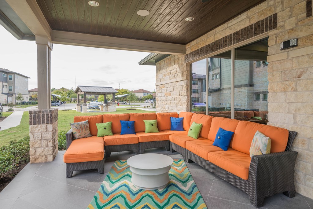 A patio with a sofa and a table.