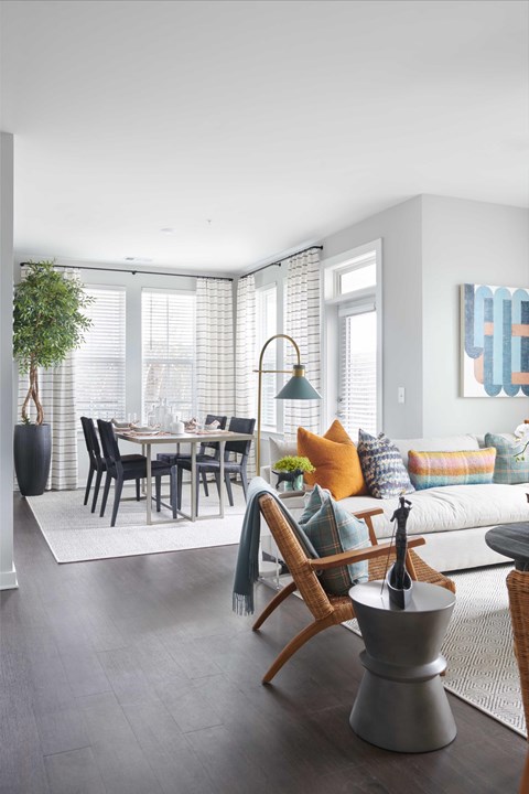 A modern living room with a dining table and chairs.