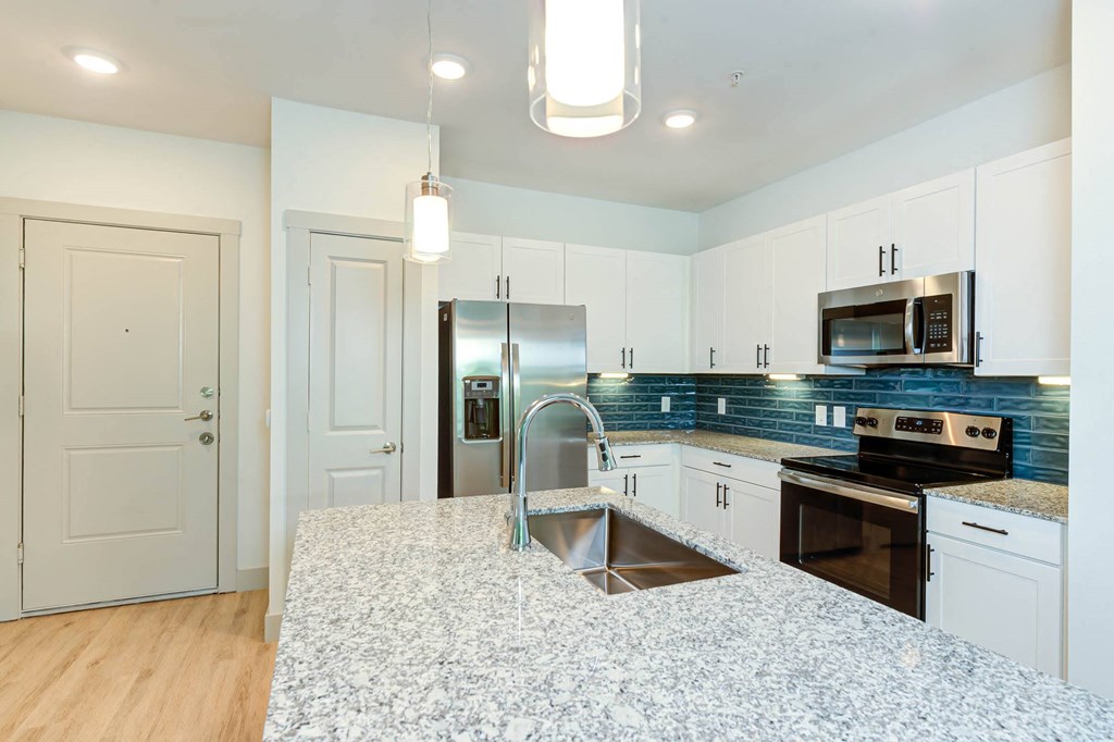 a kitchen with white cabinets and a counter top at Legacy at Cibolo, Boerne, TX