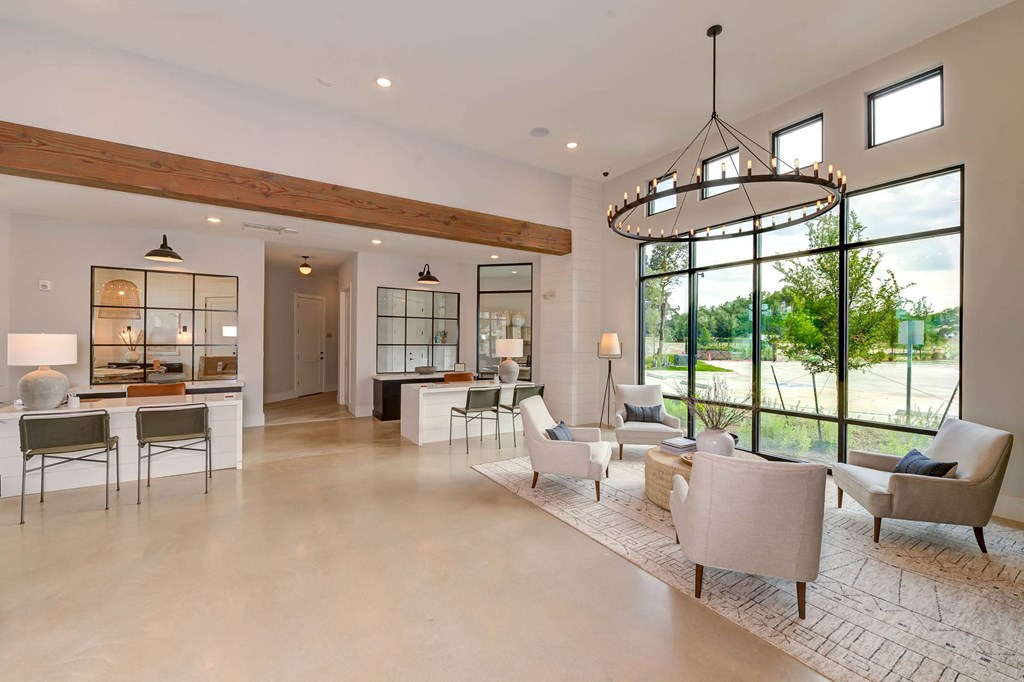 a large living room with chairs and tables and a large window at Legacy at Cibolo, Boerne, TX