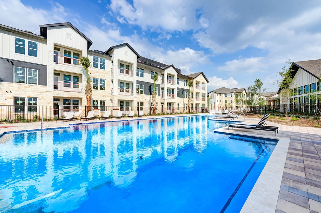 a large swimming pool in front of an apartment building at Legacy at Cibolo, Boerne, TX, 78006