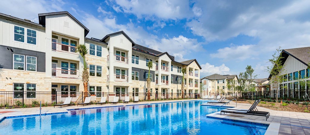 a swimming pool is in front of an apartment building at Legacy at Cibolo, Boerne, TX, 78006
