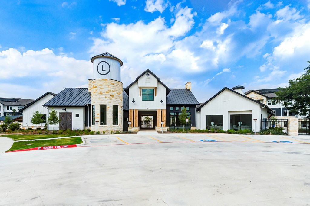 the exterior of a building with a parking lot and a clock tower at Legacy at Cibolo, Boerne