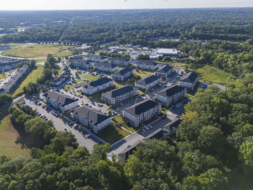 A bird's eye view of a large residential complex surrounded by trees at Waterleaf at Neely Ferry Apartments, South Carolina