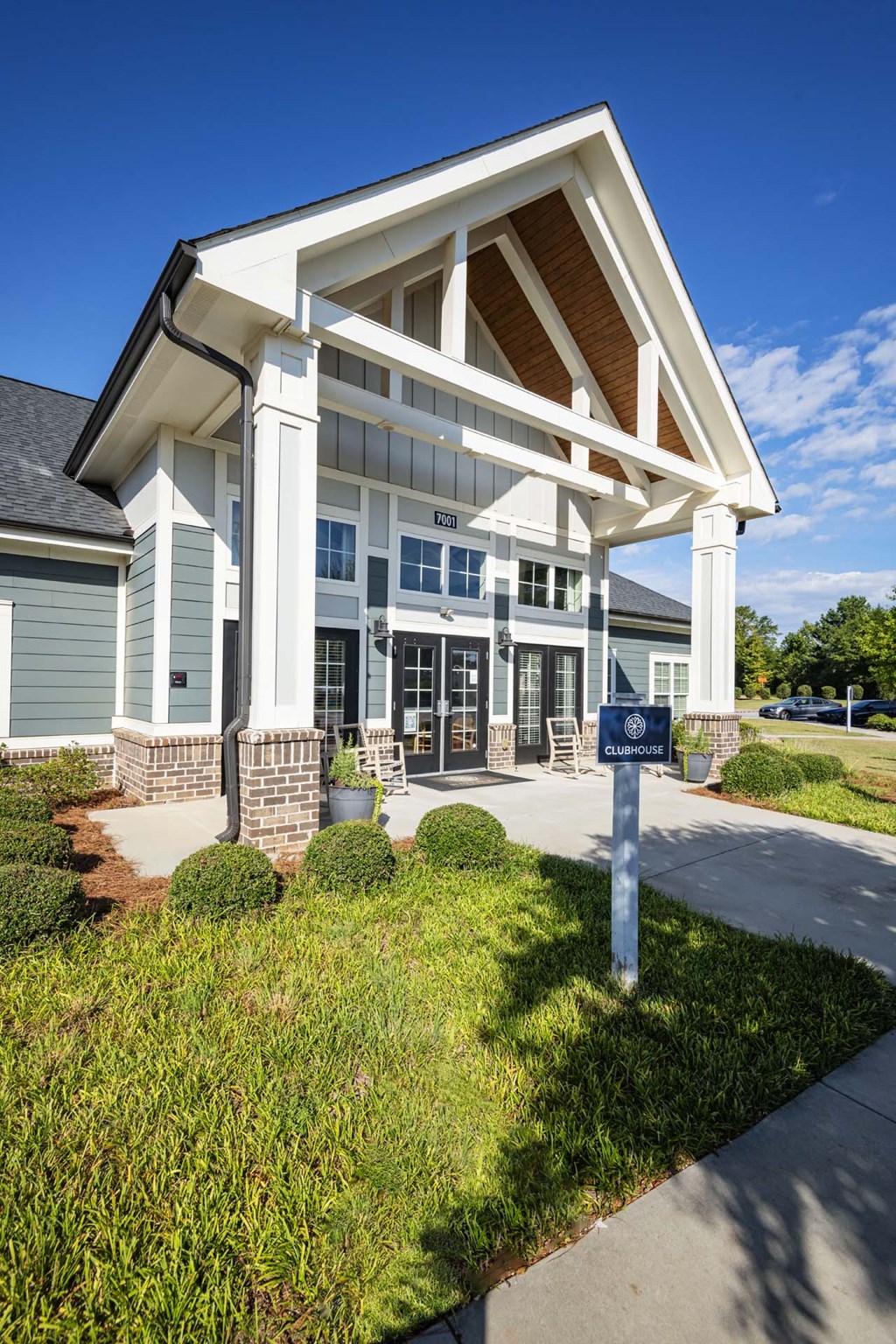 A building with a white and grey facade has a sign in front of it at Waterleaf at Neely Ferry Apartments, Simpsonville, SC 29680
