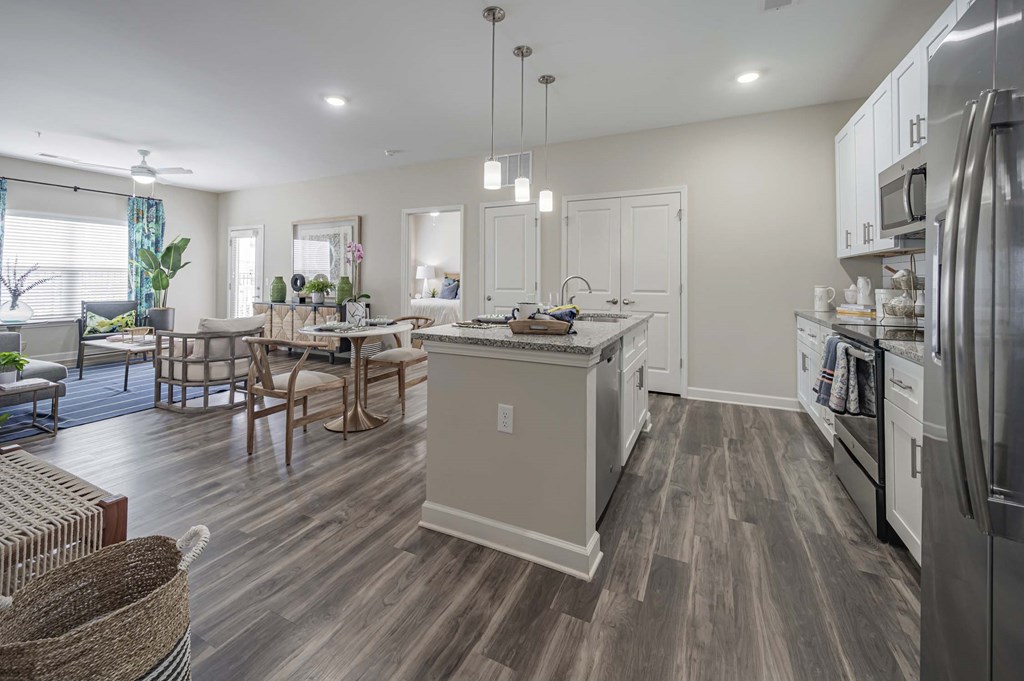 A modern kitchen with a dining table and chairs at Waterleaf at Neely Ferry Apartments, Simpsonville, SC