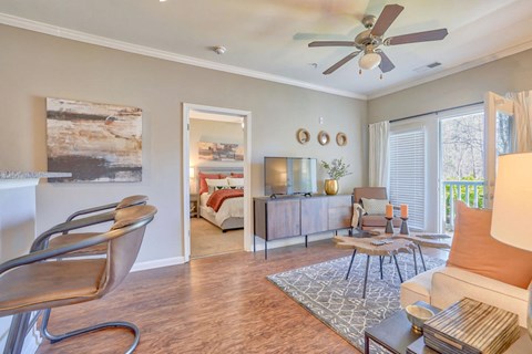 a living room with a couch and a ceiling fan