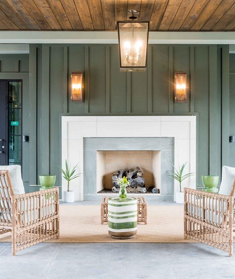 a living room with a fireplace and tables and chairs