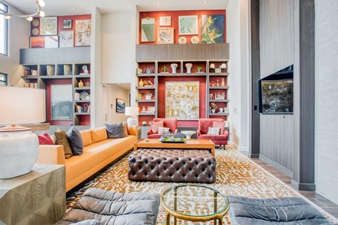 a living room filled with furniture and a book shelf