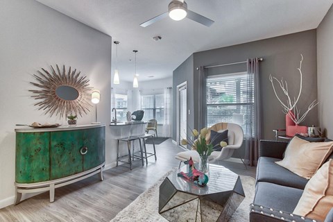 a living room with a couch and a coffee table in front of a window