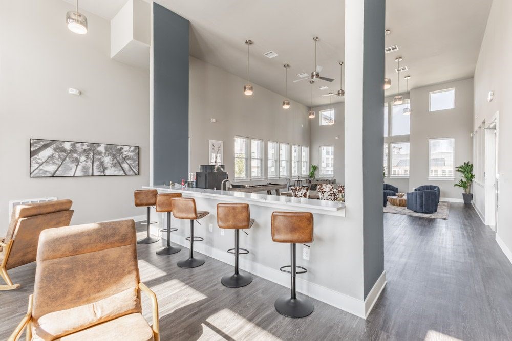Modern bar area with leather chairs and a counter at Prosper Madison Oaks, Madison, AL