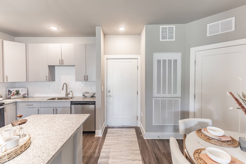 Modern kitchen with a dining table at Prosper Madison Oaks, Alabama, 35758