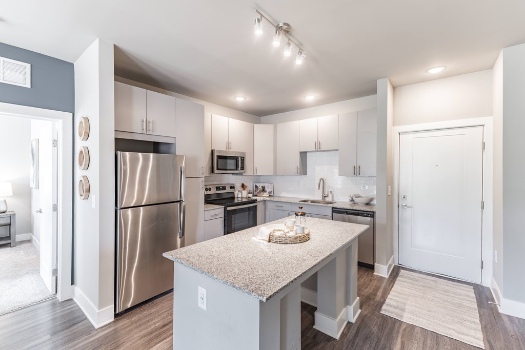 Kitchen with a refrigerator, microwave, oven, and sink at Prosper Madison Oaks, Madison, AL