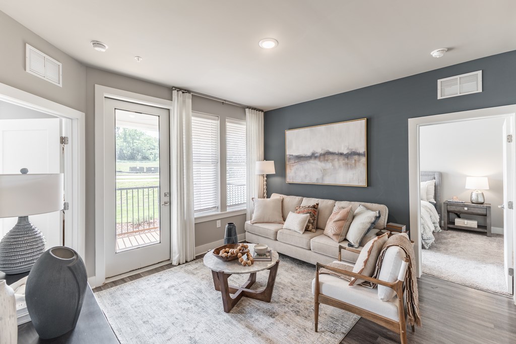 Living Room With Oversized Windows And Doors at Prosper Madison Oaks, Madison, 35758
