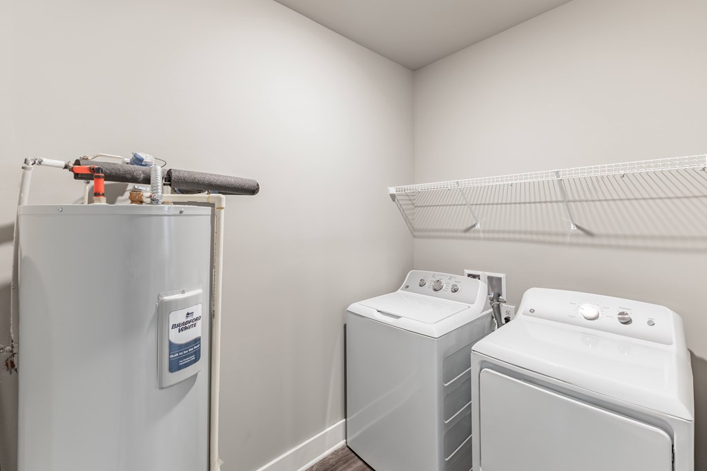 Washing machine and dryer in a small laundry room at Prosper Madison Oaks, Alabama, 35758