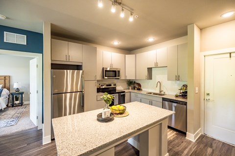A kitchen with a table in the middle of it.