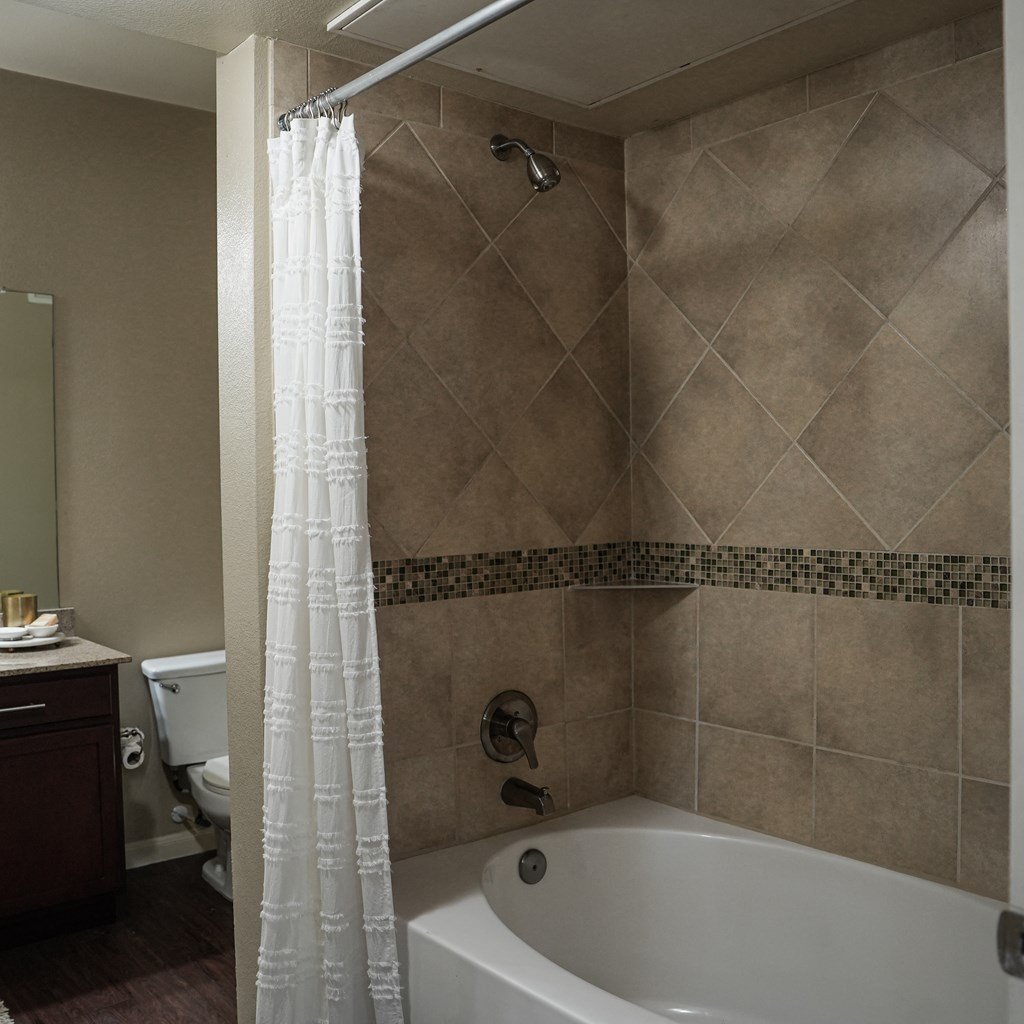 a bathroom with a tub and a shower and a toilet at Platinum Castle Hills, Lewisville, 75056