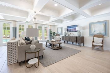A living room with a couch, a chair, and a table.