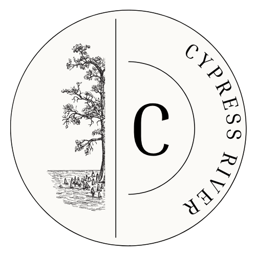 A black and white image of a tree and people in the water with the letter C in the middle.