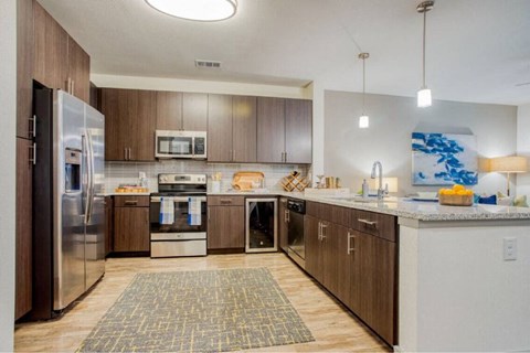 a large kitchen with wooden cabinets and stainless steel appliances