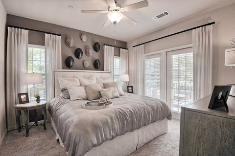 a bedroom with a bed and a ceiling fan a bedroom with a bed and a ceiling fan at Sterling Creek, Georgia