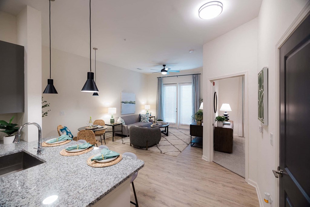 A modern kitchen with granite countertops at Hudson at Renaissance Apartments, Wilmington 28405