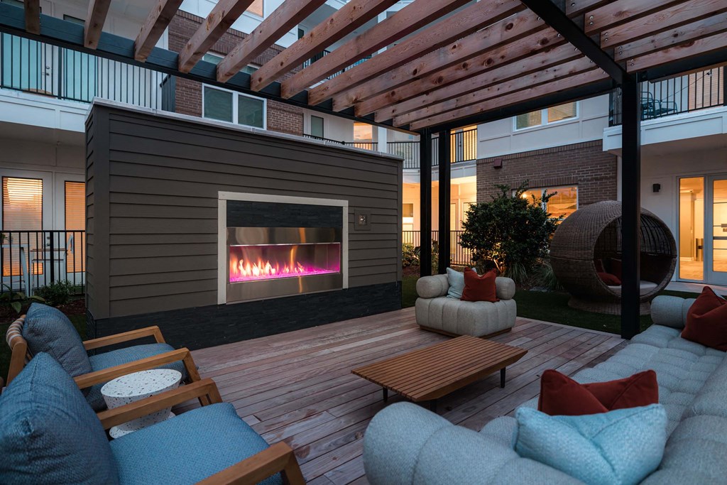 A patio with a fireplace at Hudson at Renaissance Apartments, North Carolina 28405