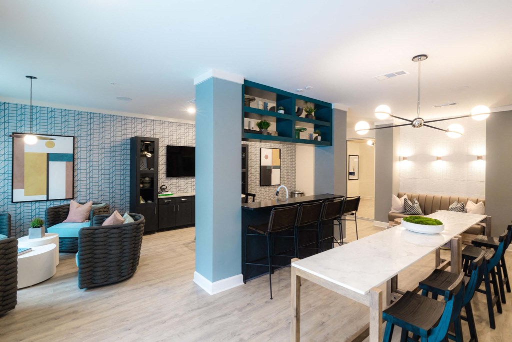A modern dining room with a white table and chairs at Hudson at Renaissance Apartments, Wilmington, NC 28405