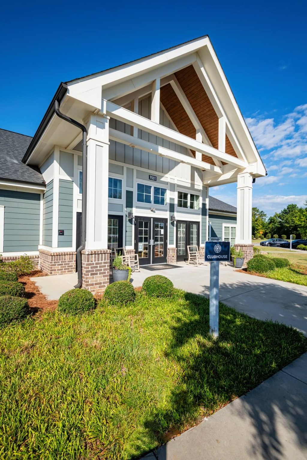 A building with a white and blue facade with a sign in front at Waterleaf at Neely Ferry Apartments, Simpsonville, South Carolina