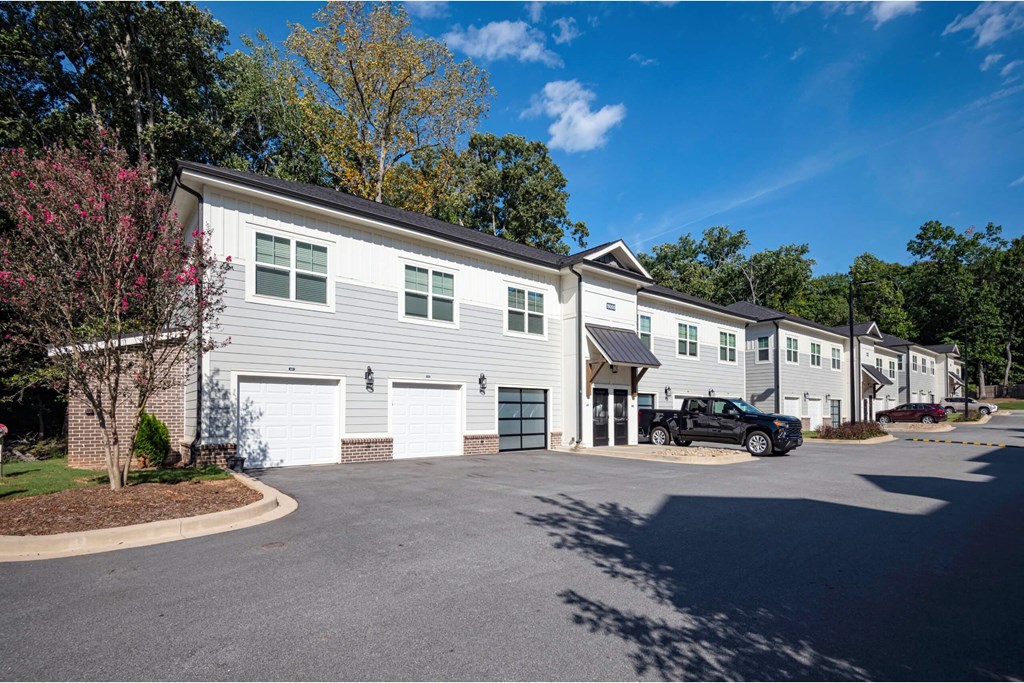 A row of houses with a car parked in front of the first one at Waterleaf at Neely Ferry Apartments, Simpsonville