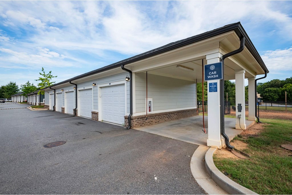 A car wash station with a blue sign above it at Waterleaf at Neely Ferry Apartments, South Carolina 29680