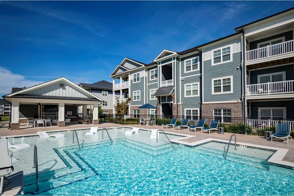 A swimming pool in front of apartment buildings at Waterleaf at Neely Ferry Apartments, South Carolina 29680