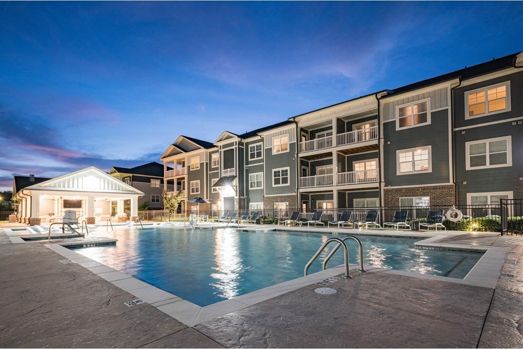 A large swimming pool is surrounded by apartment buildings at Waterleaf at Neely Ferry Apartments, Simpsonville, SC 29680