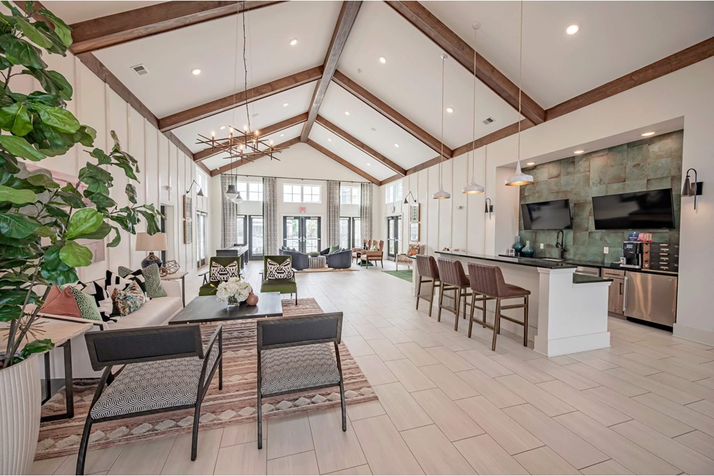 A large open living room with a kitchen area in the background at Waterleaf at Neely Ferry Apartments, Simpsonville, SC