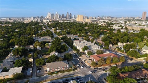 A cityscape with a mix of residential and commercial buildings.
