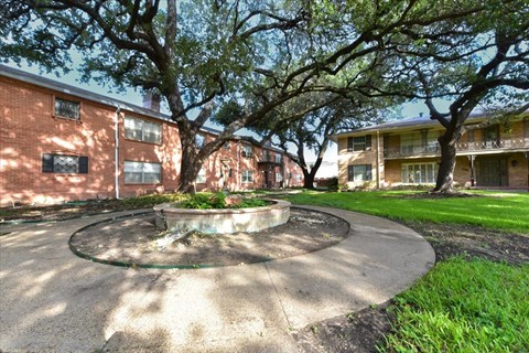 A courtyard with a fountain surrounded by apartment buildings.