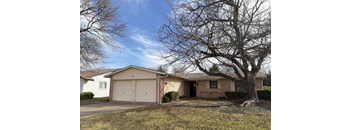 A house with a tree in front of it.