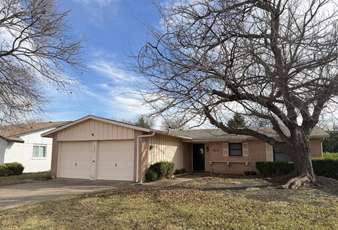 A house with a tree in front of it.