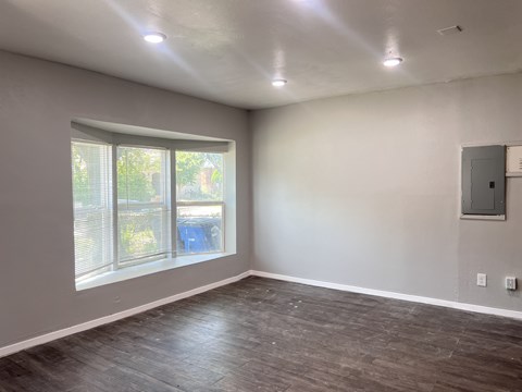 A room with a window and a wall-mounted electrical panel.