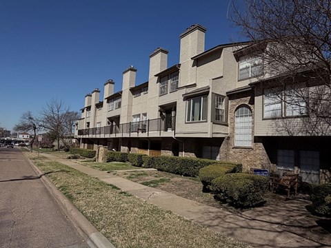 Apartment building with a row of chimneys on the roof.