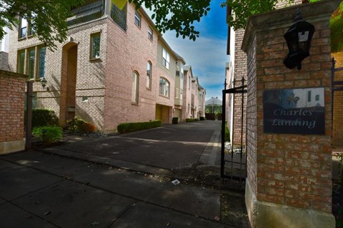 A brick building with a sign that says Charles Landing.