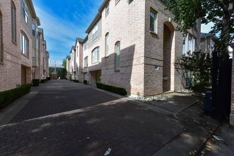 A long, narrow street between two rows of houses.
