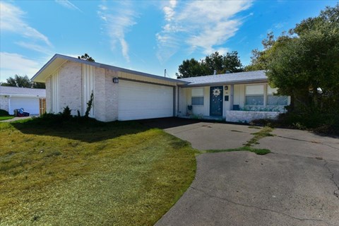 A house with a white garage door and a blue door.
